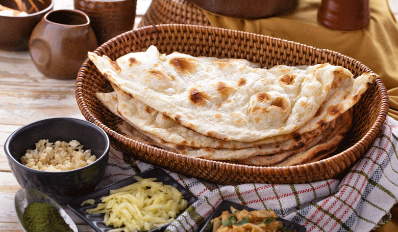 Naan bread as accompaniment to yoghurt potato curry